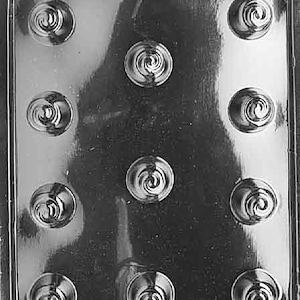 May include: A clear plastic mold with nine round cavities, each featuring a swirl design. The mold is designed for making chocolate candies.