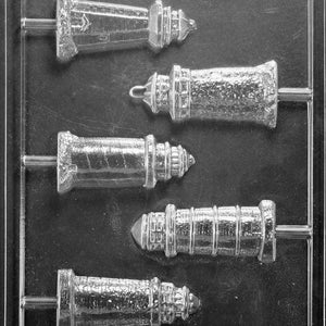 May include: A clear plastic mold with five different sized lighthouse shapes. The mold is designed for making chocolate candy. The mold is labeled "Life of the Party H-534".