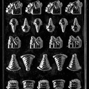 May include: A black and white plastic mold for making chocolate candies. The mold has 20 different shapes, including presents, party hats, ice cream cones, and cakes. The mold is labeled "Life of the Party" and "K102".