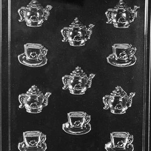 May include: A plastic mold for making chocolate teacups and teapots. The mold has nine cavities, each with a different design. The teacups and teapots have a classic, vintage look.
