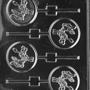 May include: A clear plastic mold for making four round lollipops. Each lollipop mold features a cartoon donkey design. The mold has a text label that reads "LIL' OF THE PARTY, GRR88G, FDA APP'D 93".
