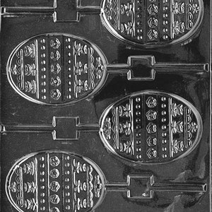 May include: A clear plastic Easter egg-shaped candy mold. The mold has four oval cavities with decorative patterns, including floral and dotted designs. Each egg shape has a stick attached for easy handling.