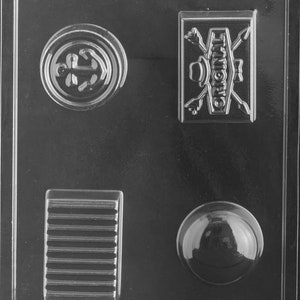 May include: Clear plastic mold with four distinct shapes: a circular design, a rectangular shape with horizontal lines, a rectangular shape with the word "ORIGINAL" and crossed arrows, and a sphere. The mold is labeled "LIFE OF THE PARTY ZM 2".
