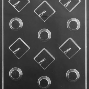 May include: A black plastic mold with 12 cavities for making chocolate candies. The mold has a diamond shape with a small figure inside each cavity. The mold also has 6 round cavities. The mold has the text "Life of the Party" printed on the bottom.