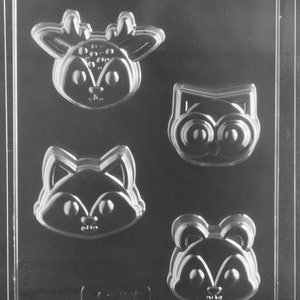 May include: A clear plastic mold with four cavities for making chocolate candies. The cavities are shaped like a deer, an owl, a fox, and a raccoon.