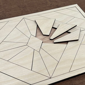 May include: A wooden puzzle with a geometric design. The puzzle has a central hole with four triangular pieces that fit into the hole. The puzzle is made of light wood with black lines.
