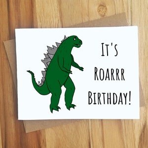 May include: A white card with a green dinosaur illustration and the text "It's Roarrr Birthday!"