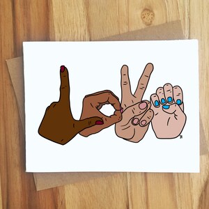 May include: A greeting card with a colorful illustration of hands spelling out the word "LOVE" in sign language. The hands are different skin tones and have painted nails.