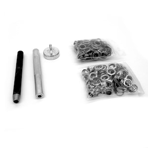 May include: A collection of metal eyelets and tools for crafting. The set includes a black punch, a silver punch, a setting tool, and two bags of eyelets. The eyelets are silver and black.