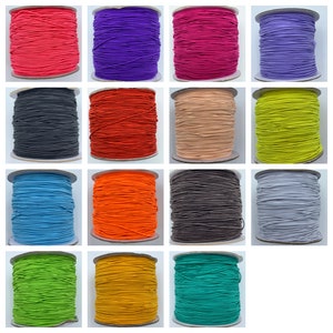May include: A collection of spools of colorful elastic cord. The spools are arranged in three rows of four. The colors include red, purple, pink, lavender, black, orange, beige, yellow, blue, neon orange, gray, light gray, green, gold, and teal.