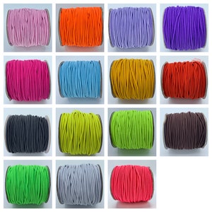 May include: A collection of spools of colorful elastic cord. The colors include pink, orange, purple, red, blue, yellow, black, green, gray, and neon pink.