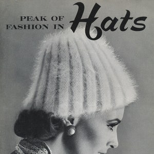 May include: A black and white photo of a woman wearing a white fuzzy hat. The text "Peak of Fashion in Hats" is at the top of the image. The text "Fleisher Bear Brand Botany" is at the bottom of the image.