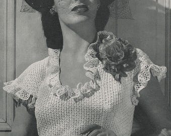 May include: A black and white photo of a woman wearing a crocheted top with a ruffled neckline and short sleeves. She is also wearing a black hat with a veil and long black gloves. A large flower is pinned to the top.