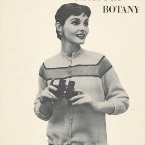 May include: Vintage black and white image of a woman wearing a button-up cardigan with horizontal stripes. The text reads "a new fashion by NOMOTTA BOTANY" and "CARDIGAN BLOUSON Style KW-27". The woman is holding binoculars.