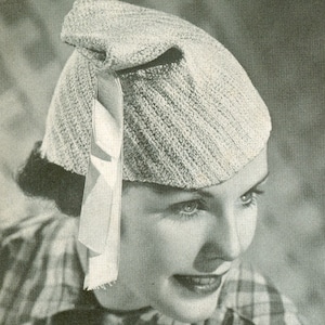 May include: A white knitted hat with a bow on the side. The hat is made of a soft, textured yarn and has a simple, elegant design.