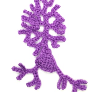 May include: Purple crocheted neuron with a large cell body and multiple dendrites and axons.