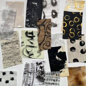 May include: An assortment of abstract art pieces on a white background. The pieces feature various textures, including brushstrokes, splatters, and circular patterns, in shades of black, brown, and gold. Some pieces incorporate text and grid lines.