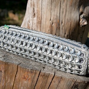 Make-up bag made of recycled can capsules.