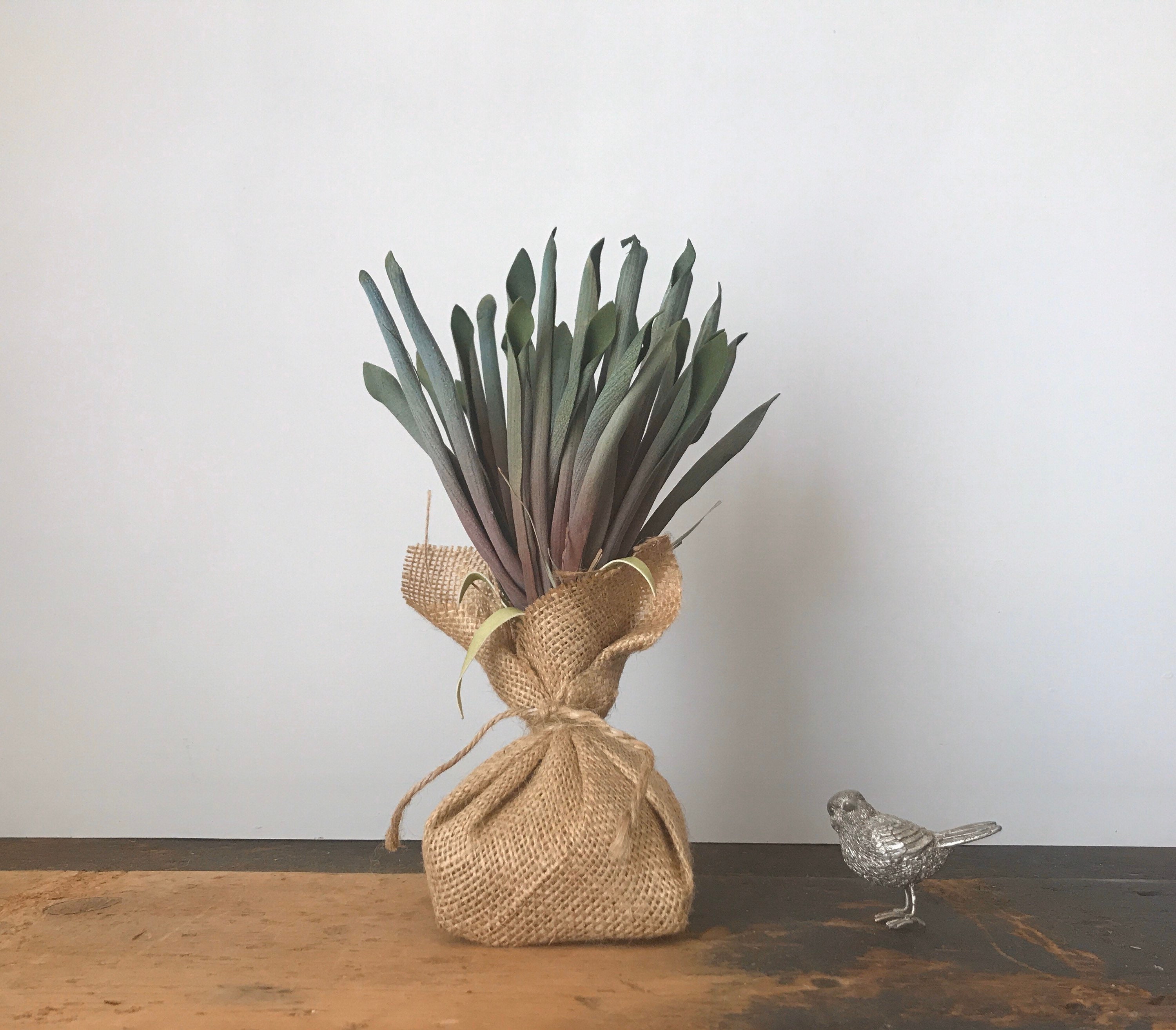 artificial faux plant wrapped in burlap