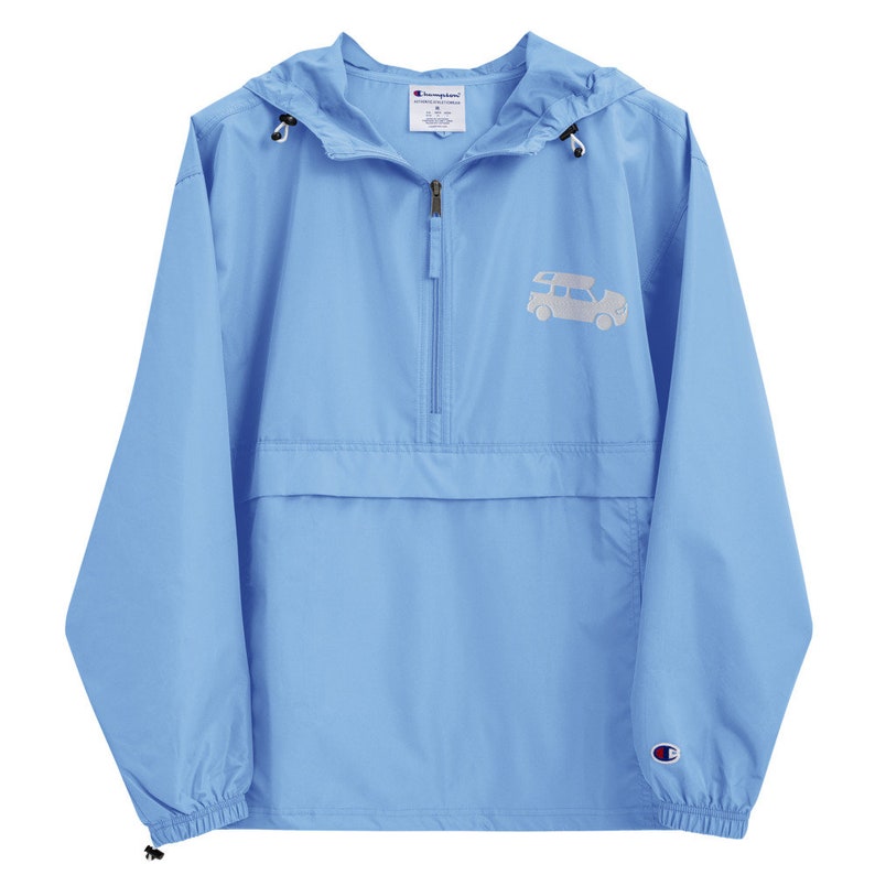 May include: A light blue Champion windbreaker with a white embroidered design of a car on the front. The jacket has a zipper closure and a hood.