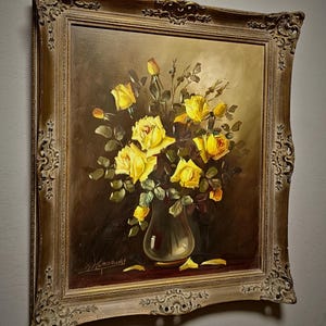 A refined large vintage oil painting of yellow roses still life, presented in a glass vase with luminous petals against a deep shadowed background, reflecting mid century European floral art traditions, with rich texture and balanced composition, ideal for collectible fine art, original artwork for sale, and botanical interior decor, suitable for living room statement wall, dining space styling, or as a gift for collectors, interior designers, or admirers of classic floral compositions