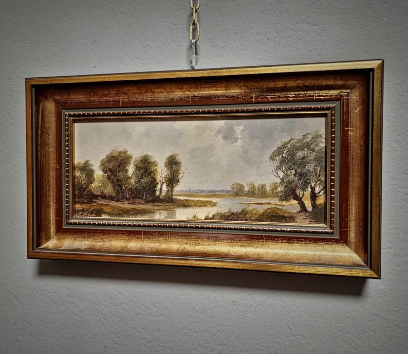 Hand painted landscape artwork depicting a German pastoral view, created in the 1950s with delicate tones and fine detail. This vintage oil painting is a collectible wall art piece ideal for living rooms, hallways, or offices. Its timeless composition adds elegance to rustic and traditional decor styles. Makes a meaningful gift for family members, friends, or coworkers during Christmas, anniversaries, weddings, or retirement celebrations. A must-have for fans of original European decor.