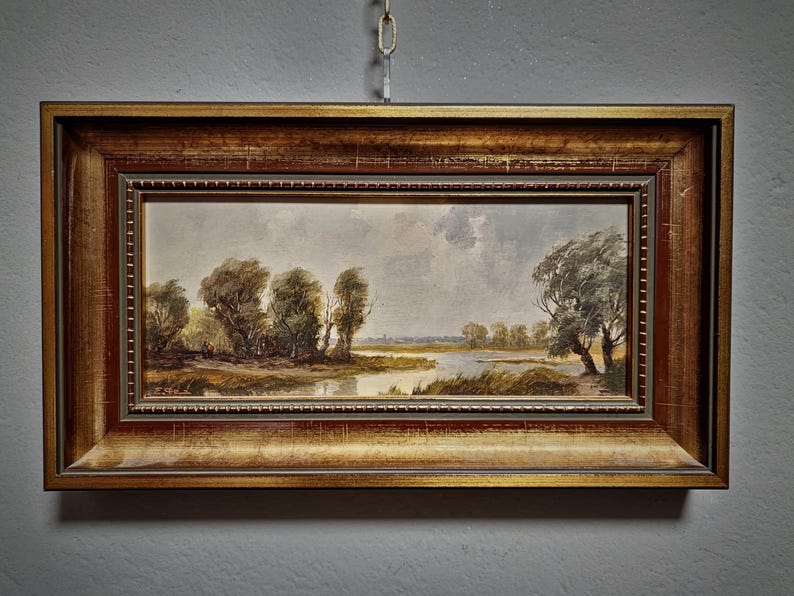 Vintage landscape oil painting featuring a panoramic European countryside, ideal for rustic farmhouse decor and mid-century wall design. This signed original artwork by a German artist captures a tranquil nature scene with warm tones and textured brushstrokes Perfect for collectible fine art enthusiasts and lovers of classic wall decor, this piece suits living room wall art, offices, and refined interiors. A thoughtful gift for art lovers, collectors and those who value original artwork for sale