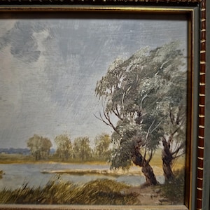Original vintage artwork depicting a peaceful countryside scene in earthy green and brown tones, this European landscape oil painting is perfect for mid-century farmhouse decor and collectors of antique paintings for sale. Its signed authenticity, rich texture, and traditional frame make it a timeless addition to gallery walls or elegant home settings. A wonderful present for those who love rural artwork, interior design, or unique wall decorations.