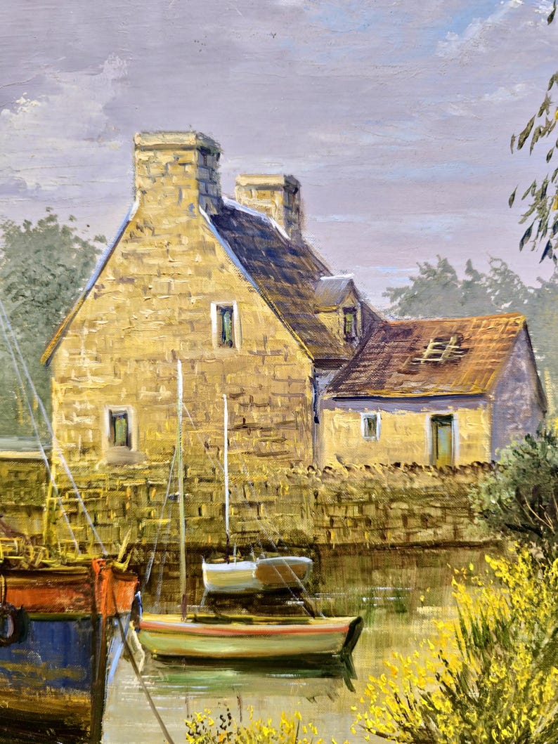May include: Oil painting of a coastal scene featuring a stone building with a tiled roof and chimneys. Small sailboats are docked in the water, with a larger boat on the left. The painting has a warm color palette with yellow, brown, and blue hues.