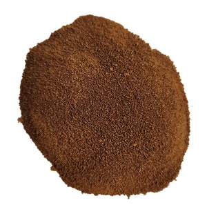May include: A close-up of a pile of brown instant coffee granules.