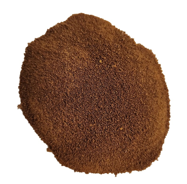 May include: A close-up of a pile of brown instant coffee granules.