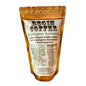 May include: A gold foil pouch of Begin Coffee Adaptogenic Awakening instant organic coffee infused with adaptogenic mushrooms and ashwagandha. The pouch is 120 grams and lists the ingredients and directions for use.