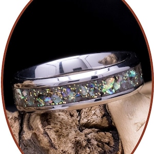 Könnte beinhalten: Ein silberner Ring mit einem Band aus irisierendem Abalone-Schalen und Glitzer.