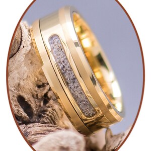 May include: A gold tungsten carbide ring with a band of embedded wood. The ring has a beveled edge and a polished finish.