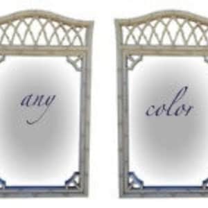 May include: Pair of white, rectangular framed mirrors with a decorative lattice design on the top. The mirrors have a simple, elegant design.