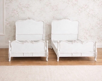 Pair of twin beds finished in a white with distressed edges