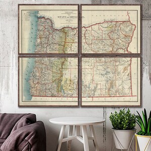May include: A vintage map of the state of Oregon, divided into four sections, showing county boundaries and major rivers. The map is printed on aged paper with a cream background and red and blue lines. The map is framed in a rustic wooden frame.