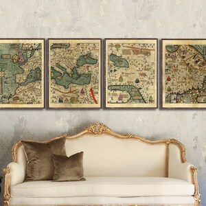 May include: Four antique-style framed maps of the world, each with a different section of the globe, are displayed on a wall above a white couch with two brown throw pillows.