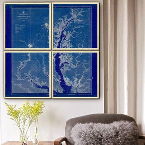 May include: A set of four vintage nautical charts of the Chesapeake Bay, printed in blue and white on a cream background. The charts are framed and displayed on a white wall.