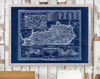 May include: Framed vintage map of Kentucky in a blue and white color scheme. The map features detailed cartography, including geographical features and place names. The frame is a light, neutral color, enhancing the map's vintage aesthetic.