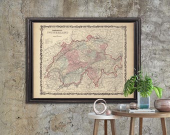 May include: A framed vintage map of Switzerland with a detailed outline of the country's cantons. The map is displayed on a textured concrete wall with two wooden side tables and decorative objects.