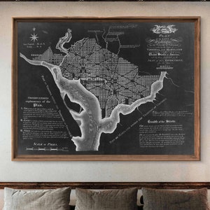 May include: Black and white vintage map of Washington, D.C. The map shows the city's layout, streets, and surrounding areas. The title reads "Plan of the City of Washington, in the Territory of Columbia, Virginia and Maryland, United States of America, Seat of the Government, 1791."
