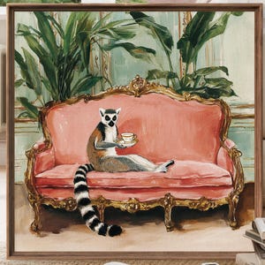May include: A framed artwork depicts a lemur lounging on a pink antique sofa, holding a teacup and saucer. The lemur has a black and white ringed tail. The background features lush green plants and a light blue wall. The sofa has ornate gold trim.