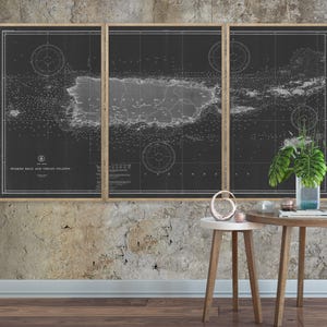 May include: A black and white vintage map of Puerto Rico and the Virgin Islands, framed in a wooden frame. The map is displayed on a textured wall with two small wooden tables and decorative objects.