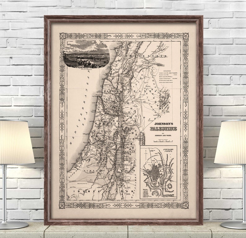 May include: A vintage map of Palestine, titled "Johnson's Palestine", showing the journey of Jesus and Paul. The map is printed in black and white on a cream-colored paper and framed in a brown wood frame.