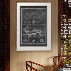 May include: A black and white vintage world map print in a silver frame. The map shows the continents and oceans, with lines indicating wind patterns and rain.