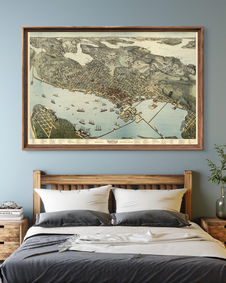 May include: A vintage map of Seattle, Washington, showing the city's layout and surrounding waterways. The map is printed in a detailed style with a brown frame.