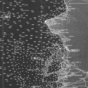 May include: A black and white map of the coast of Puerto Rico, showing the location of Mayaguez Bay and surrounding areas. The map includes depth soundings, navigational aids, and other important features for mariners.