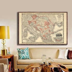 May include: A vintage map of Austria, Turkey, and Greece. The map is printed in black and white with red and pink highlights. The map is framed in a brown wooden frame.