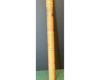 May include: A rolled-up vintage newspaper, cylindrical in shape, with visible text and images. The paper is a light brown color, with the text printed in black ink. The top of the roll has the words "Costa Go-Ahead" visible.